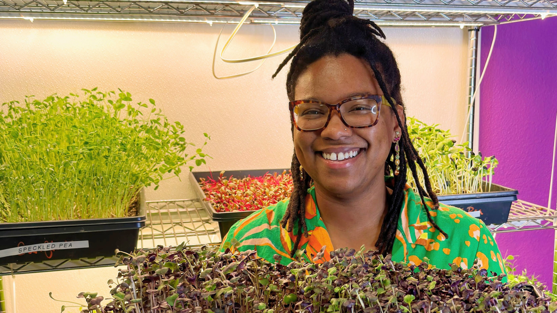 Black woman holding microgreens